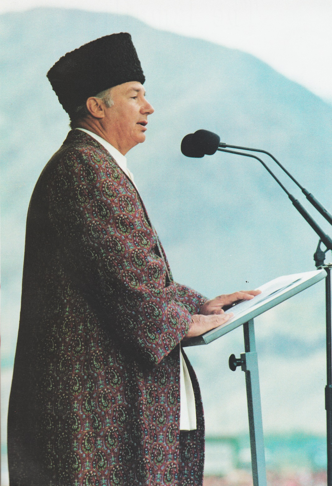 The Aga Khan wearing a black Persian hat, with a long, flowing purple coat covered with gold filigree, addresses his Ismaili followers during his visit to Tajikistan in 1995. Photo: The Ismaili, Special issue, 1995.