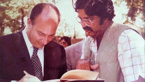 Aga Khan signing Smiling Safari by photographer Azhar Chaudhry