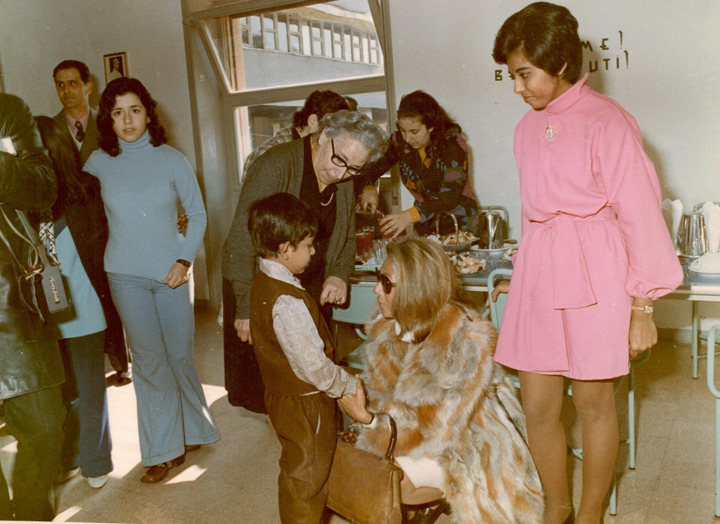 Princess Catherine Aga Khan with a refugee boy at camp in Italy.