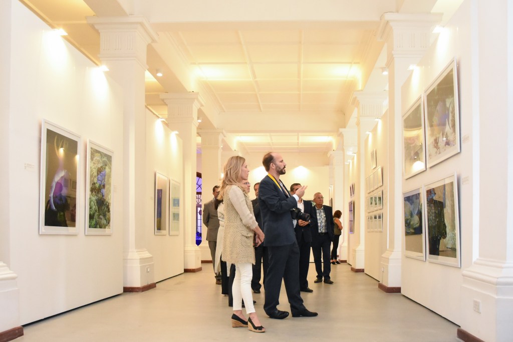 Prince Hussain is accompanied by Princess Fareen -- then Elizabeth Hoag; they were engaged when this photo was taken in March 2019 -- as he describes the elements of a particular photograph at Nairobi’s Town Jamatkhana during an exhibition of his stunning photos of marine life.  Photo: AKDN/Aziz Islamshah 