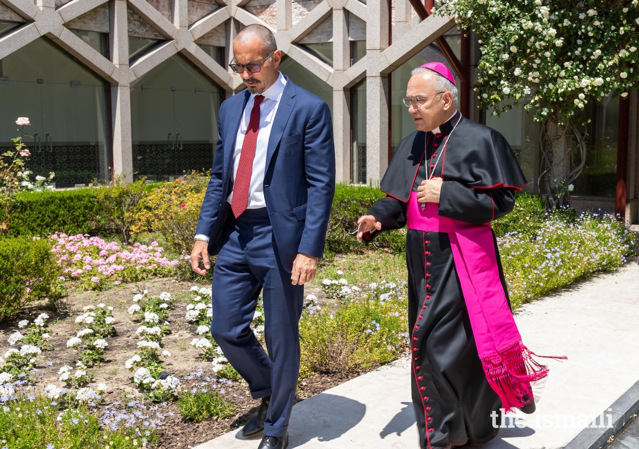 Prince Rahim Aga Khan and Monsignor Peña Parra walk through the courtyard garden at the Ismaili Centre, Lisbon.
