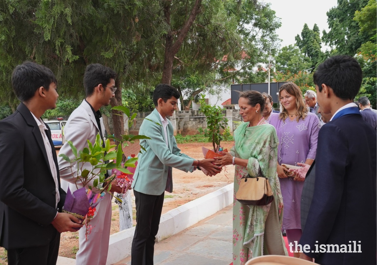 Students at the Aga Khan Hostel in Kompally presented fruit-producing plants to Princess Zahra Aga Khan as her daughter Sara, looks on.