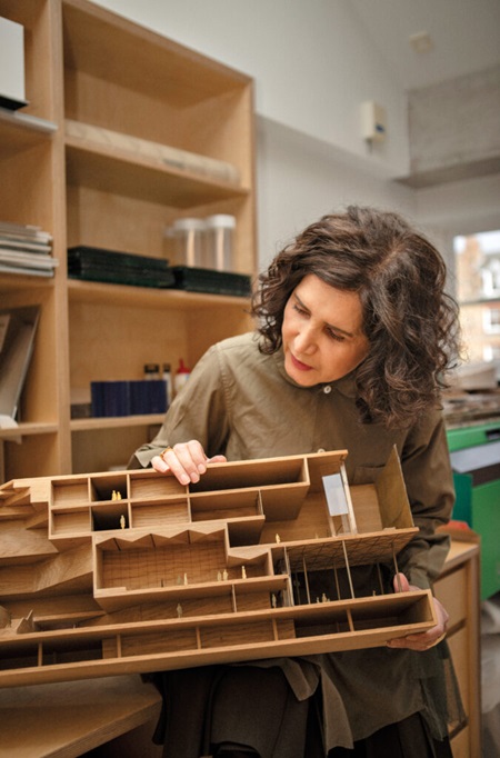 Moussavi holds up a model of the Ismaili Center Houston, a religious space for Ismaili communities. The center is currently under construction and expected to open in 2025.