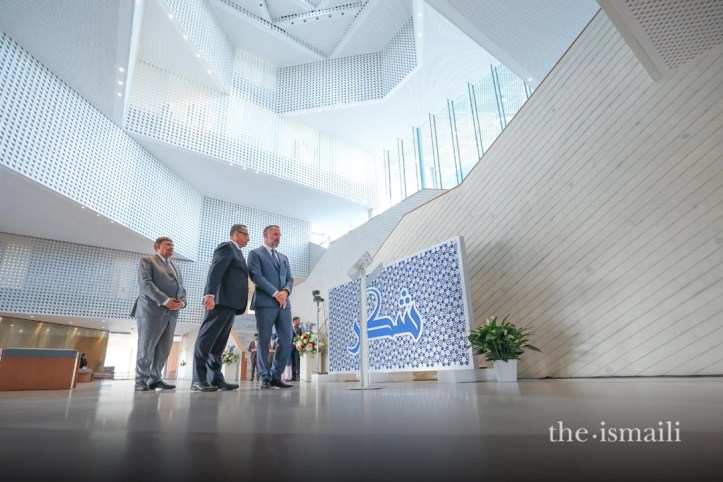 His Highness the Aga Khan admiring art work by Ismaili students at the Ismaili Center in Houston during the youth mulaqat