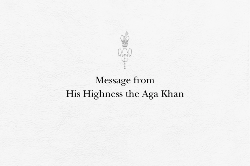 Textured white background with a centered message reading 'Message from His Highness the Aga Khan', accompanied by an ornate emblem above the text.