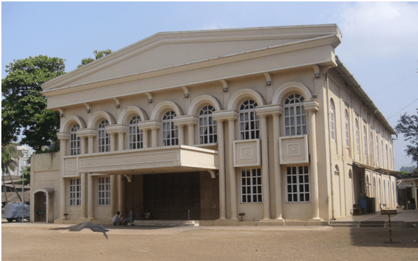 A large historic building featuring classical architectural design with multiple arched windows and a prominent entrance.